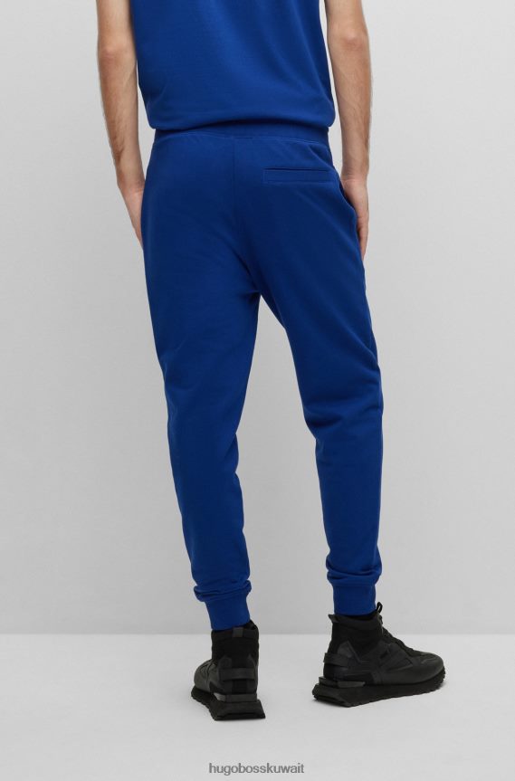 4TFNJN1953 أزرق Hugo Boss بدلة رياضية من قطن تيري مع شعار عمل فني باللون الأزرق هوغو