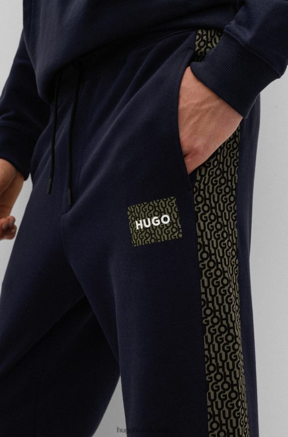 4TFNJN2571 أزرق غامق Hugo Boss بدلة رياضية من قطن تيري باللون الأزرق الداكن مع رقعة شعار وإدخالات هوغو