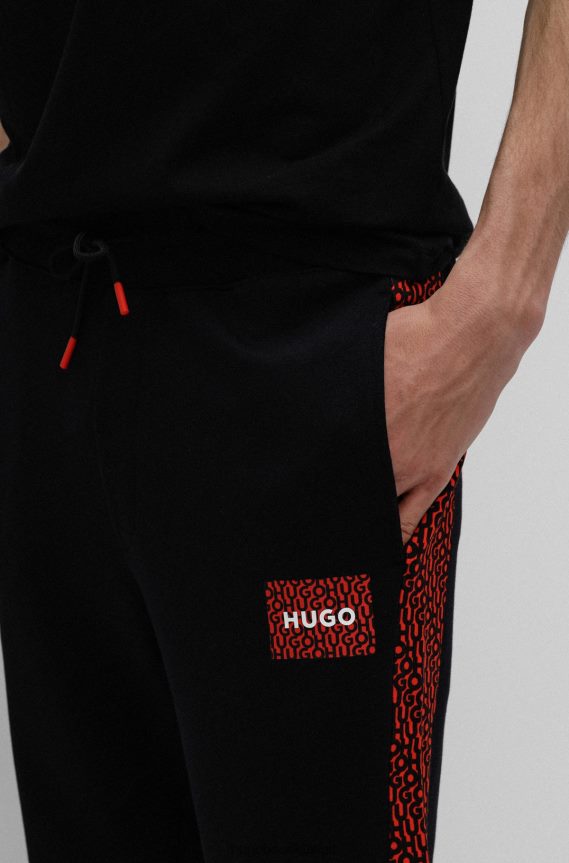 4TFNJN2573 أسود Hugo Boss بدلة رياضية سوداء من Hugo مصنوعة من قطن تيري مع رقعة شعار وإدخالات