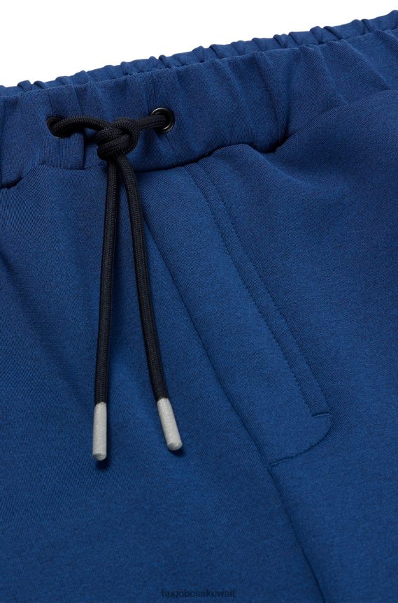 4TFNJN3537 أزرق غامق Hugo Boss قطعة سفلية رياضية من Hugo ذات قصة عادية مع تفاصيل عاكسة زخرفية باللون الأزرق الداكن