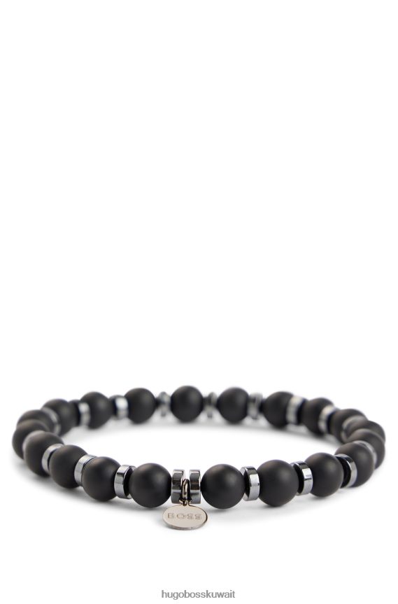 4TFNJN5431 أسود Hugo Boss سوار Hugo باللون الأسود غير اللامع من العقيق والهيماتيت مع علامة شعار معدنية