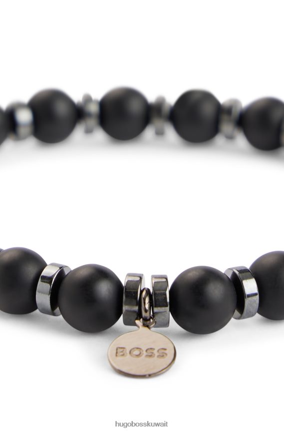 4TFNJN5431 أسود Hugo Boss سوار Hugo باللون الأسود غير اللامع من العقيق والهيماتيت مع علامة شعار معدنية